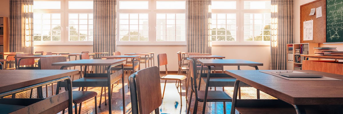 School District Upgrades Intercom System to Improve Performance, Cost, and Safety View of empty elementary classroom with light pouring into the windows