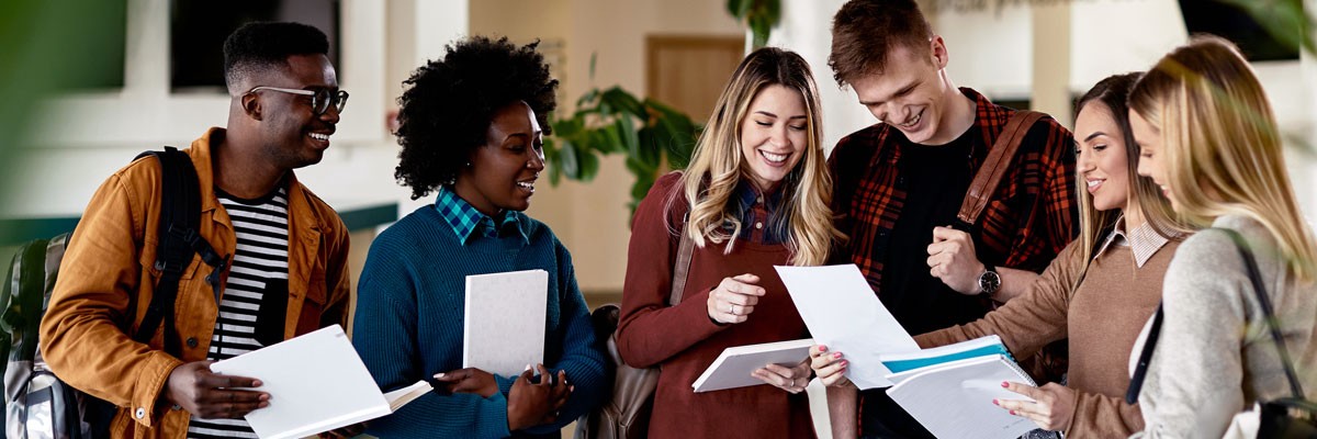 Schools Implement Advanced Technology to Support Growing Student Populations and Increasing Educational Needs Group of college students gather around on campus