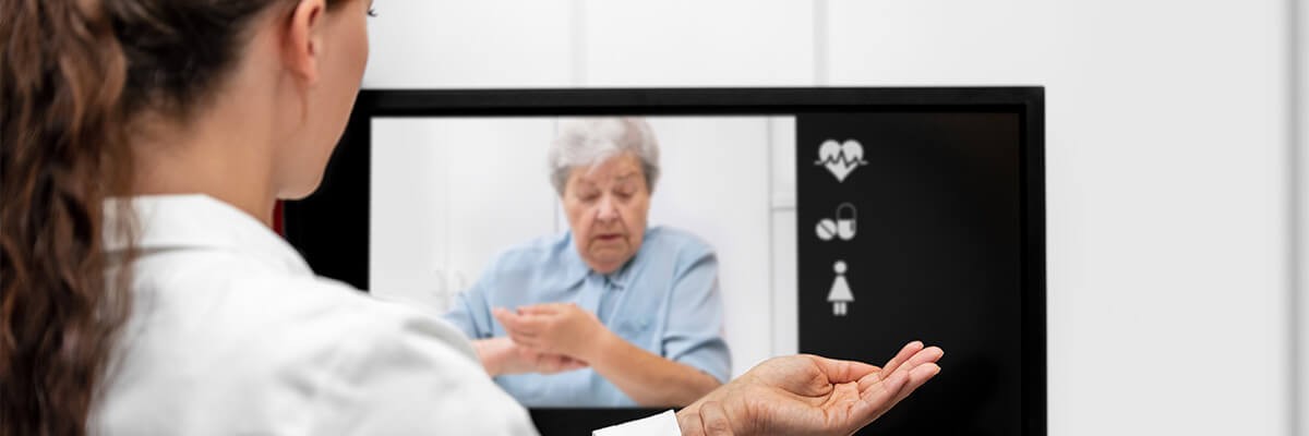 Connect your doctors and your patients under recommended physical distancing guidelines Teledoctor explaining telemedicine healthcare procedures with patent remotely.
