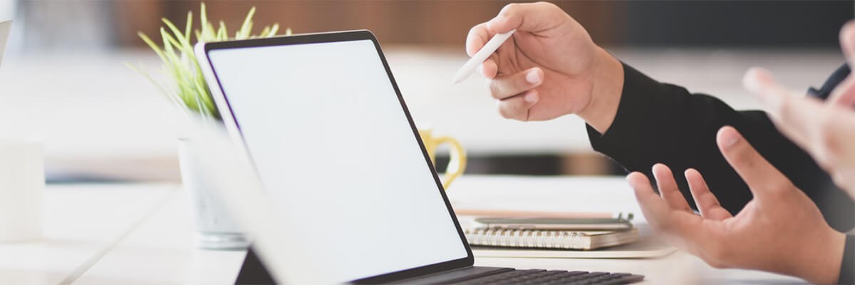 Simplify the process of procuring, maintaining and replacing the technology you invest in to run your organization. Close up of a business professional working on a tablet computer. Cisco security, client story, ISE enforcement