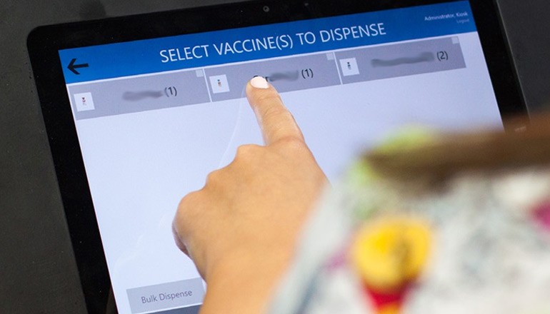 Redefining Key Data Center Services for Today’s Knowledge-Based Economy Clinician uses finger to tap on tablet information about vaccines