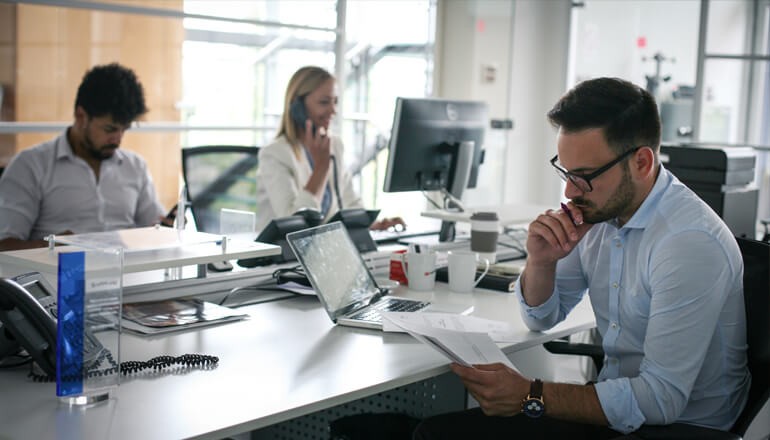 A New Model for Software Licensing Three team members working in a modern business environment