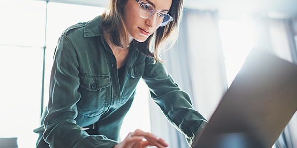 Build a backlog of targeted actions and then use the included canvas to see the desired impact Business woman downloading Insight's Agile Awareness to Action Canvas Workbook to her laptop computer