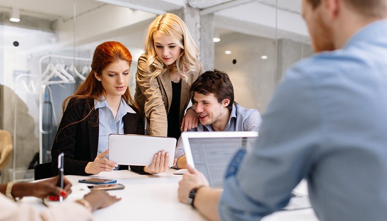 Taking Your Cloud Network to New Heights Business professionals working in modern office space using Cisco products and solutions