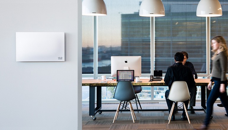 Taking Your Cloud Network to New Heights Business professionals working in modern office space using Cisco products and solutions