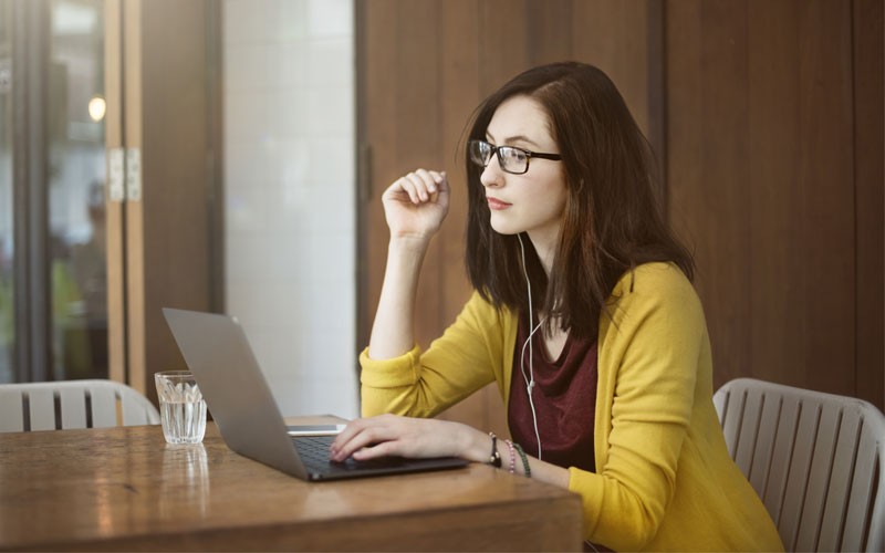 Devices have evolved Business woman working on laptop computer