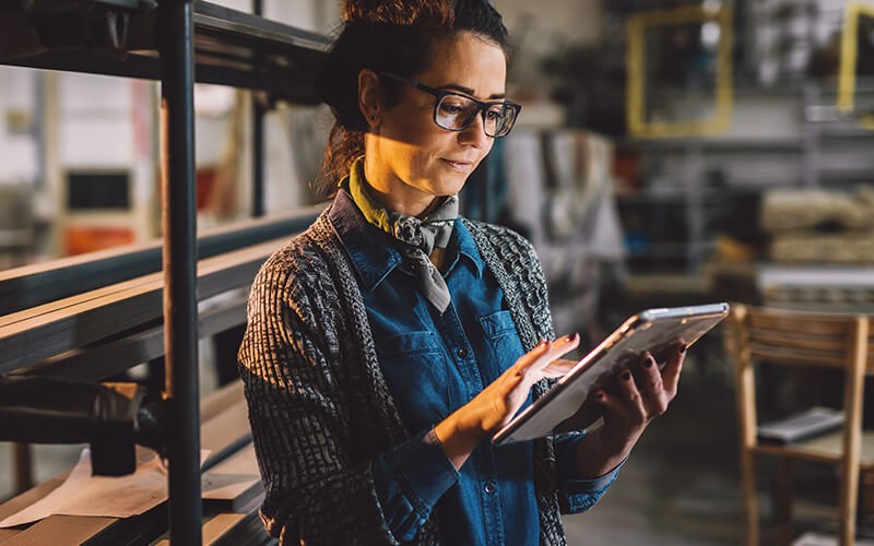 Growing businesses are adopting cloud Businesswoman sharing data on tablet computer with colleague