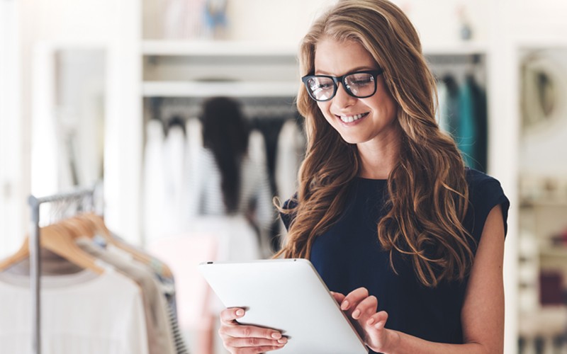 Enhance the customer and employee experience for optimal results Retail employee checking inventory on tablet computer. Enhanced customer and employee satisfaction