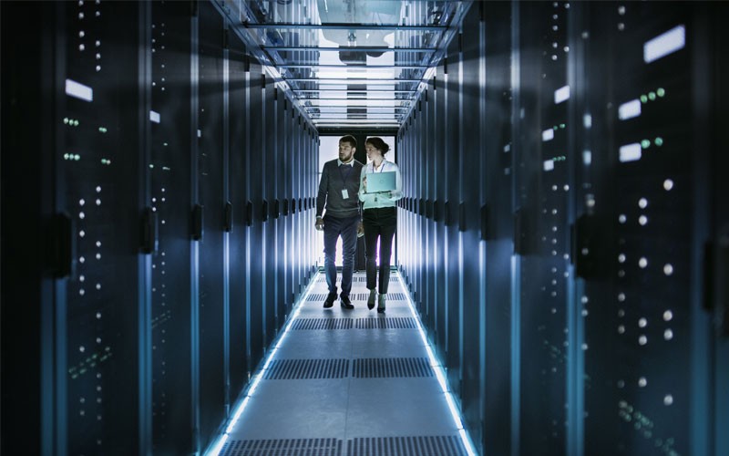 Threat Prevention and Security Automation webinar Two business professionals in server room