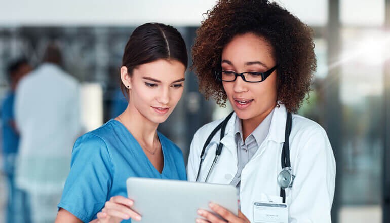 Using Cloud to Transform Healthcare Data Centers Healthcare professionals watching webinar on tablet device