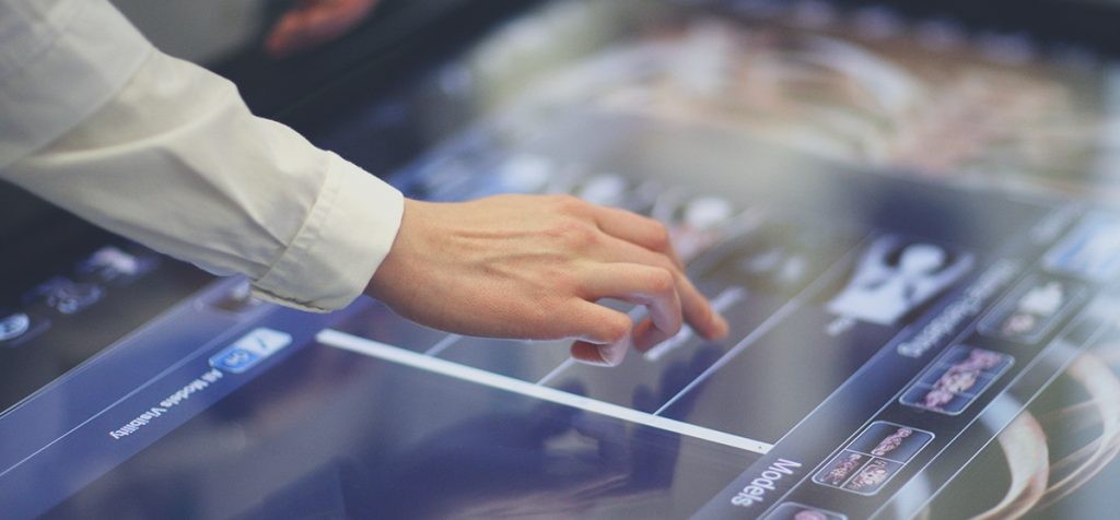 The true value of digital pathology: leveraging data to create actionable insights. Doctor hand scrolling through large screen of models for their data