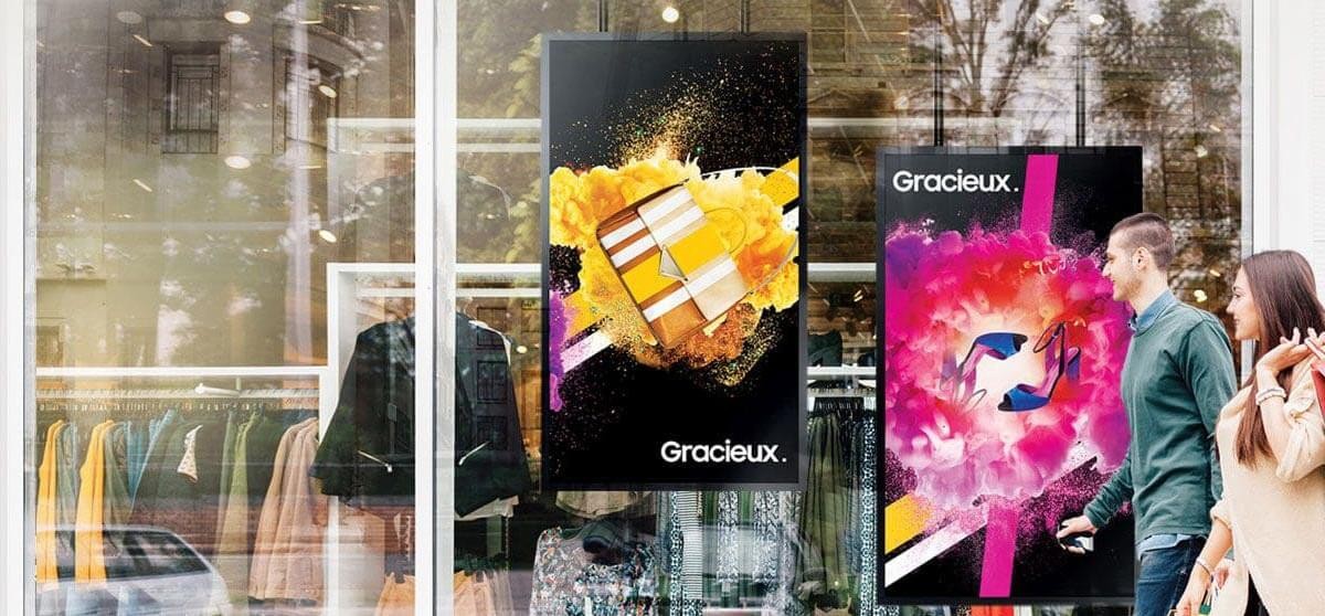 Direct view LED A man and woman walk by a retail storefront with an advertisement for an LED display technology