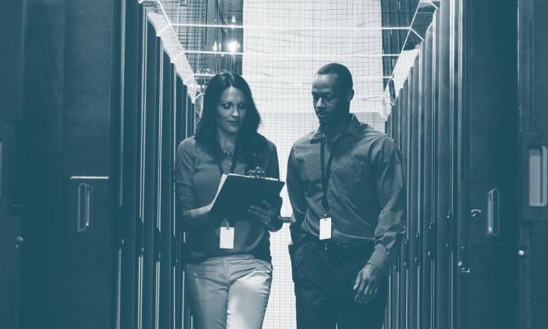 Secure application traffic A man and woman review the document on the woman's clipboard