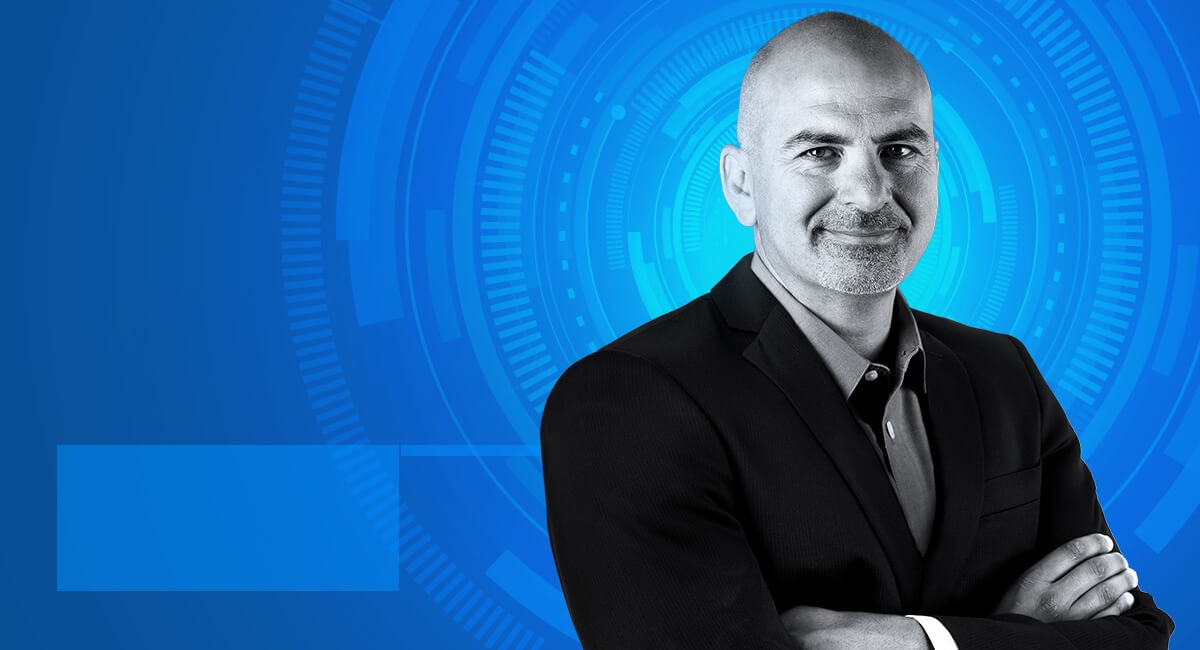 Doug Martin Doug Martin crosses arms in suit and smiles into camera