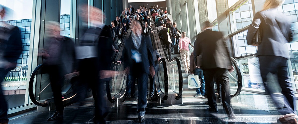 Find success with a trusted IT partner. Business professionals riding escalator. Outsourced IT management.