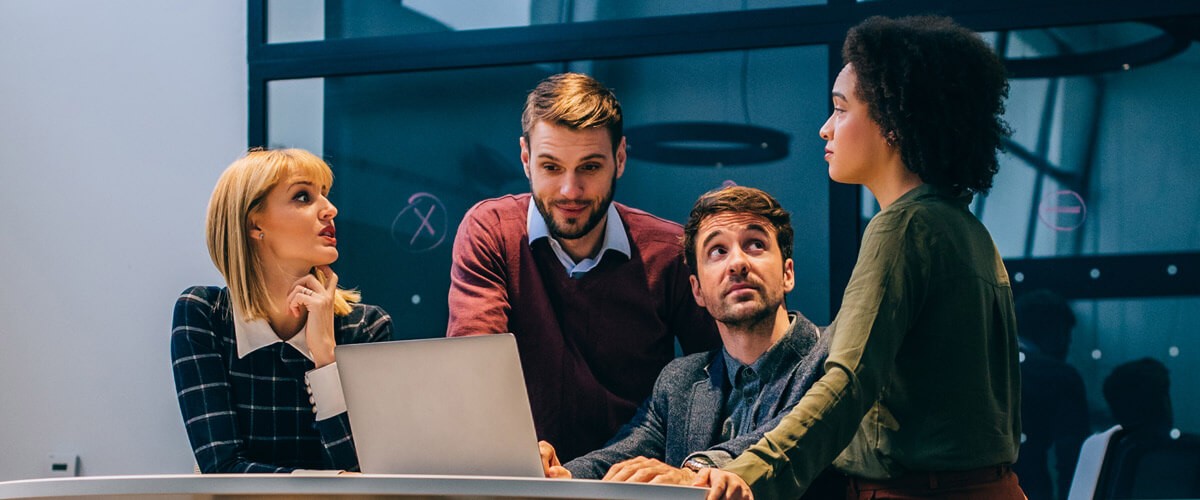 Make workstream collaboration successful Business team collaborates around computer to have project discussion. Workstream collaboration tools.