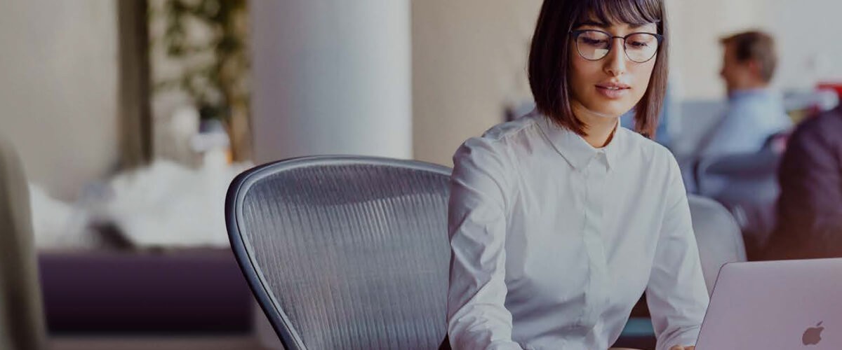 Resistant to integrating Mac at work because you think it won’t support your apps or processes? Well, Mac does that. Business woman using Mac. Mac as a choice, mac at work, mac vs. pc