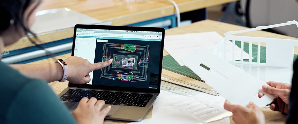 Smarter Workspaces Woman points at computer screen showing what appears to be a computer processor diagram