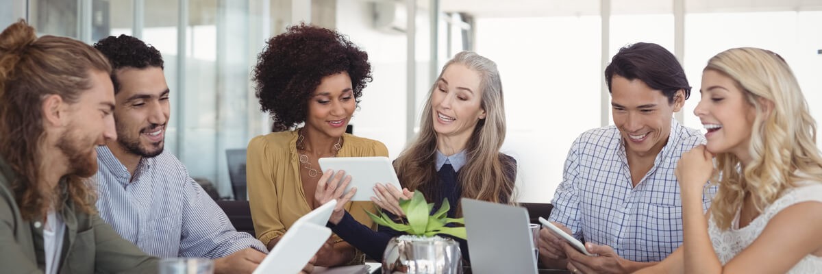 5 ways to speed up workflows with HelloSign by Dropbox Happy colleagues working on devices