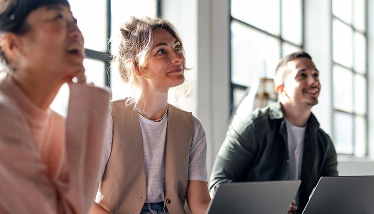 Crash Course: Building AI Agents for Real-World Business Impact Team in office listening to presentation
