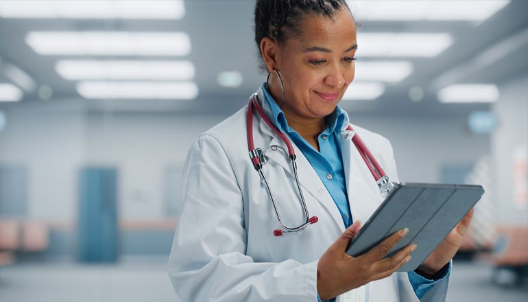 What’s in store for patient experience, data security and healthcare technology? Woman doctor using tablet device in hospital