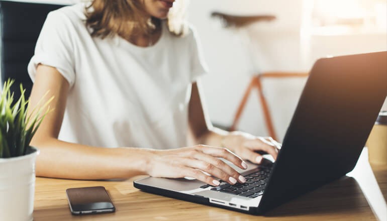 Join Insight and Microsoft for a Windows Autopilot webinar. Learn how to enable a digital workforce with zero-touch device provisioning. User on laptop at home