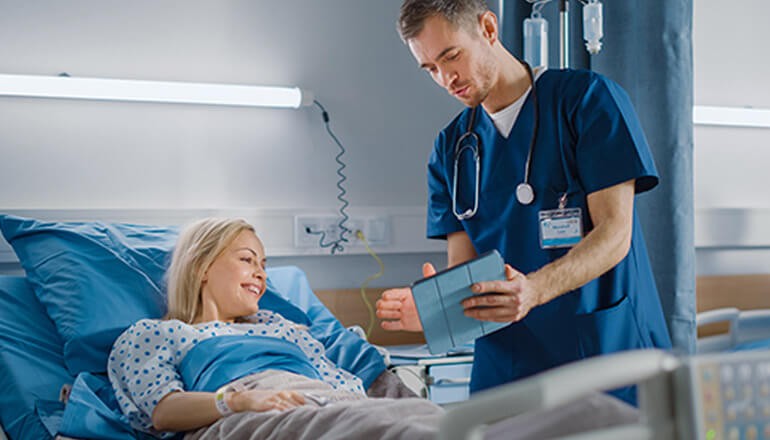 Maintain the privacy, security and flexibility healthcare organizations require Nurse talking with patient