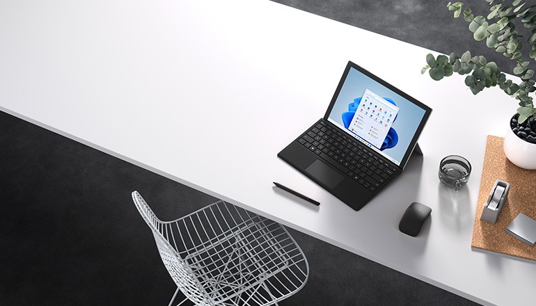 Reimagine for Success With Windows 11 webinar Microsoft Surface device on desk displaying Windows 11 OS