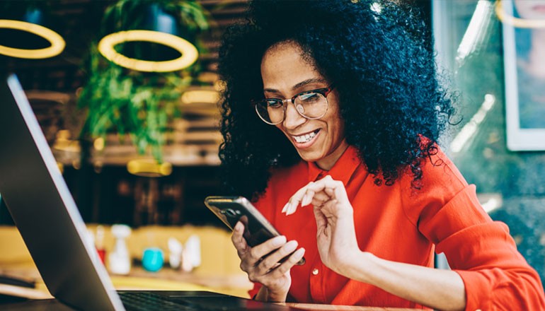 Westerra’s Journey to Modern IT With Insight and VMware Abstract concept of data and a city over a man holding a tablet device