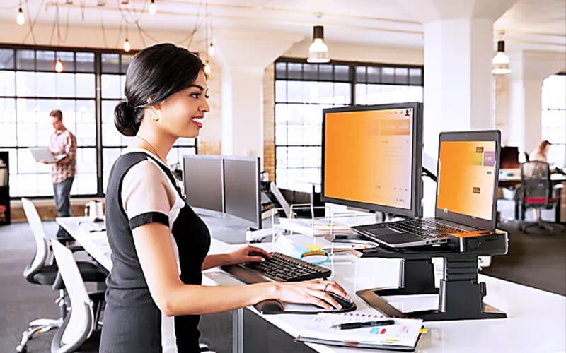 Gold Privacy Filters Woman standing in front of her station