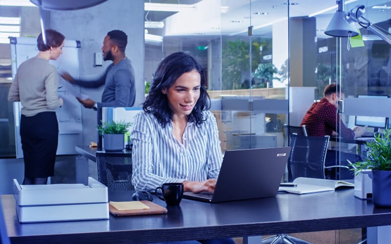 Optimize your performance. Woman usign her laptop at the office