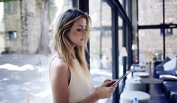For retail a woman working on a delivery with an employee using an apple device