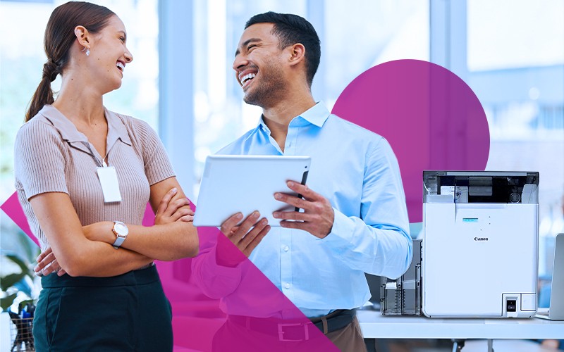 Secure ID card and badge printing two workers reviewing print with printer in background