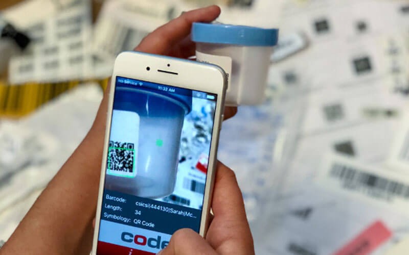 Healthcare software solutions Mobile phone scanning the bar code