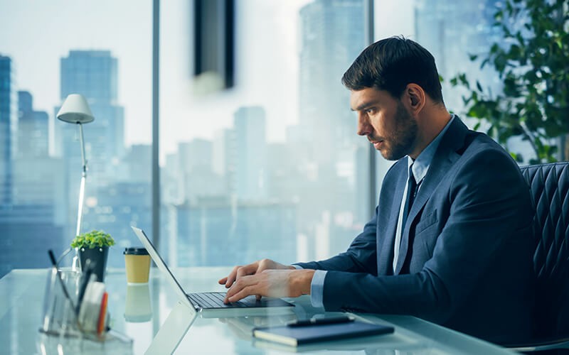 Metallic SaaS backup and recovery solutions Man working on laptop