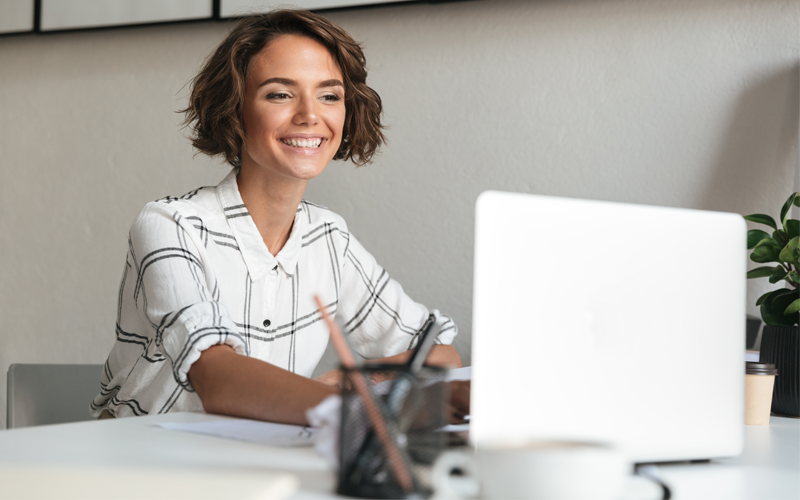 Certificate of completion for electronically signed documents Woman smiling while working on computer