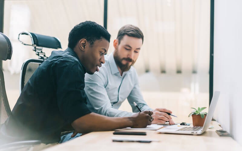 erwin data preparation software Two business men sitting while looking over tablet device
