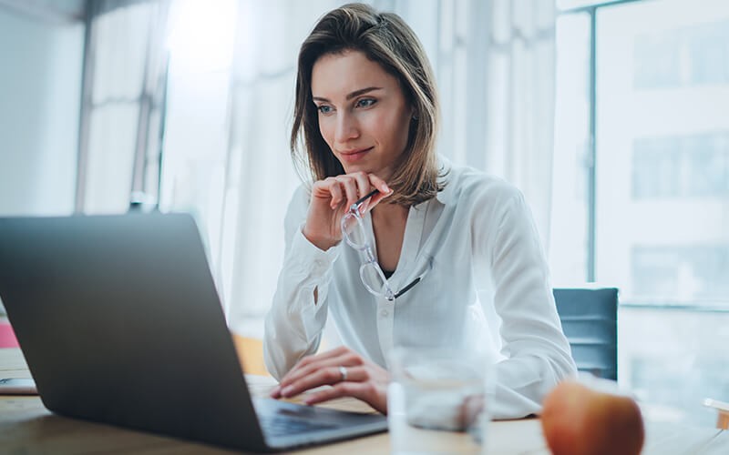 Unparalleled network connectivity Woman in glasses using a laptop