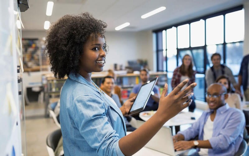 Access and analyze data from any source with Monarch Complete Two employees looking at desktop monitors