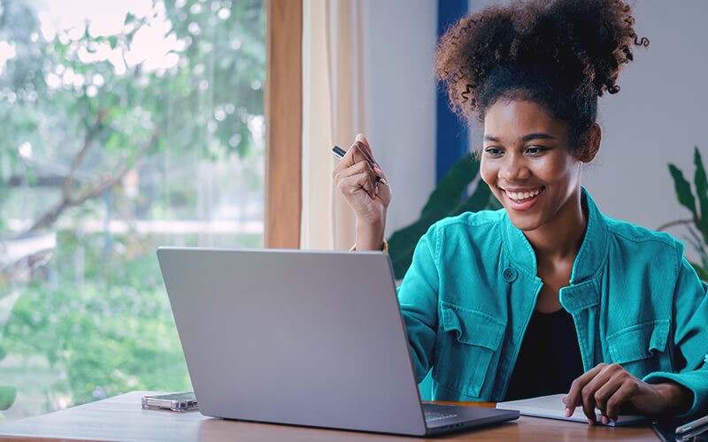 Enhanced customer experiences Curly hair woman using her laptop