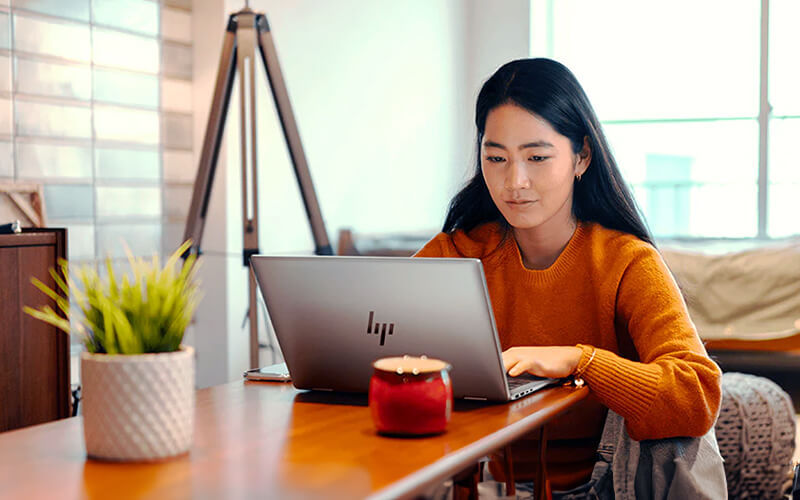 Need more? Choose add-ons. Woman using a laptop