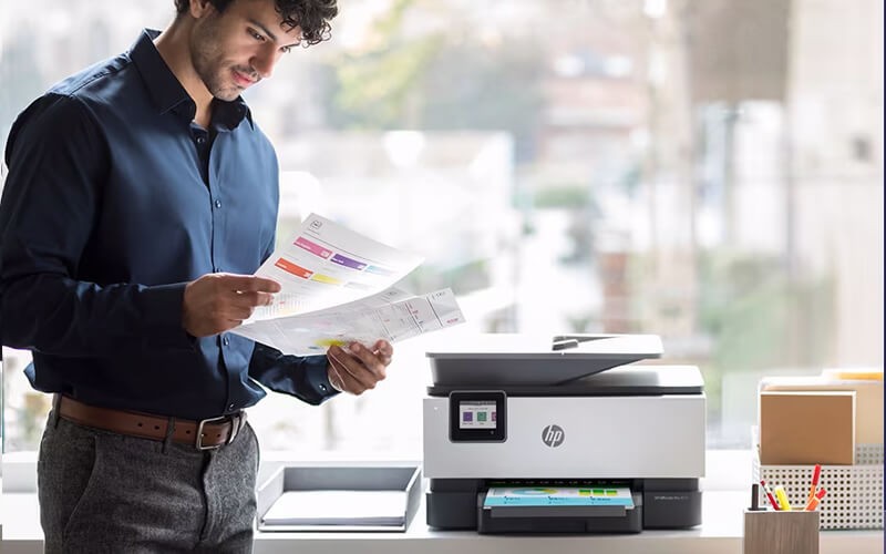 Performance you can count on Man standing next to HP printer