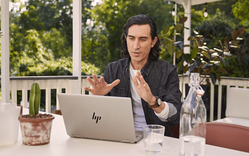 Let AI do the work for you Man using a HP laptop outside