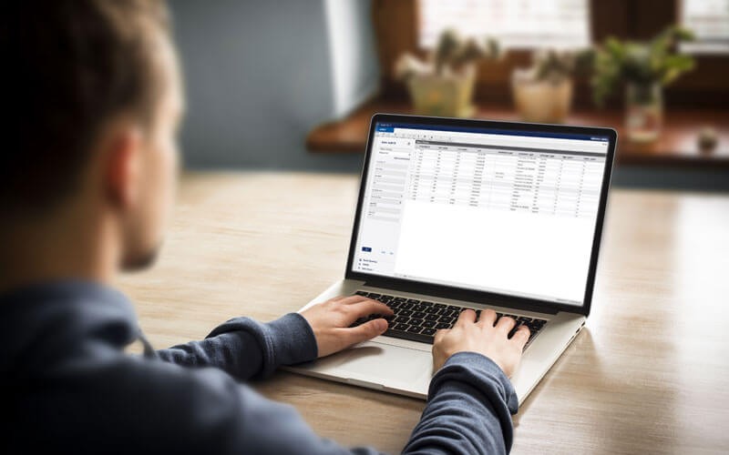 Image API Axiom Pro Male using laptop displaying Axiom Pro software