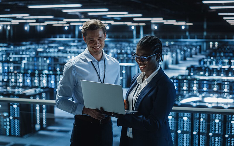 Kemp Flowmon Solutions Two person collaborating inside the data center