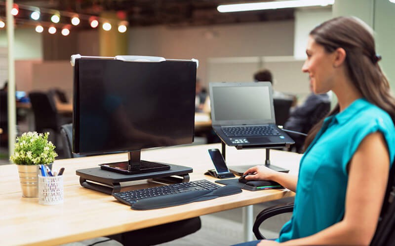 Anytime, anywhere privacy Woman using her privacy monitor at work