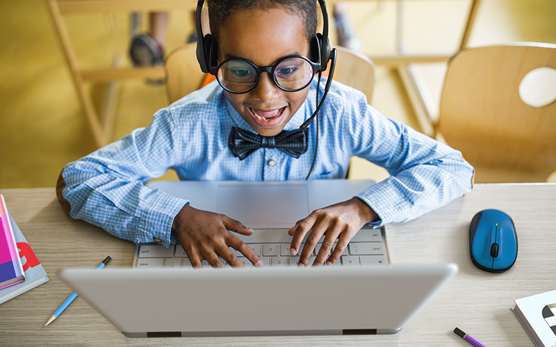 Eliminate distractions and boost productivity A happy kid using Chromebook laptop
