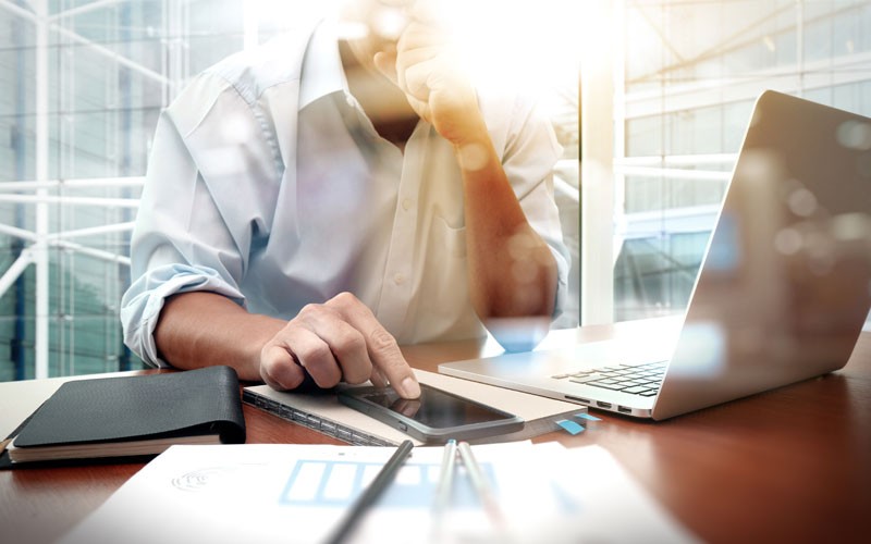 You can deliver new business value by modernizing core systems and processes Businessman working on laptop