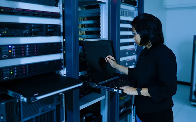 Deliver unparalleled service management to IT and business users Professional working on laptop