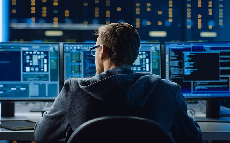 Smarter service management Male IT working infront og multiple screen